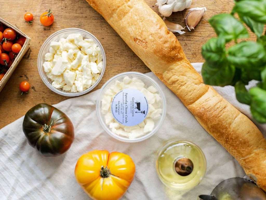 cheese bread and tomatoes on a table