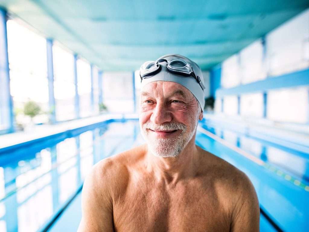 Older man in a swim cap and goggles