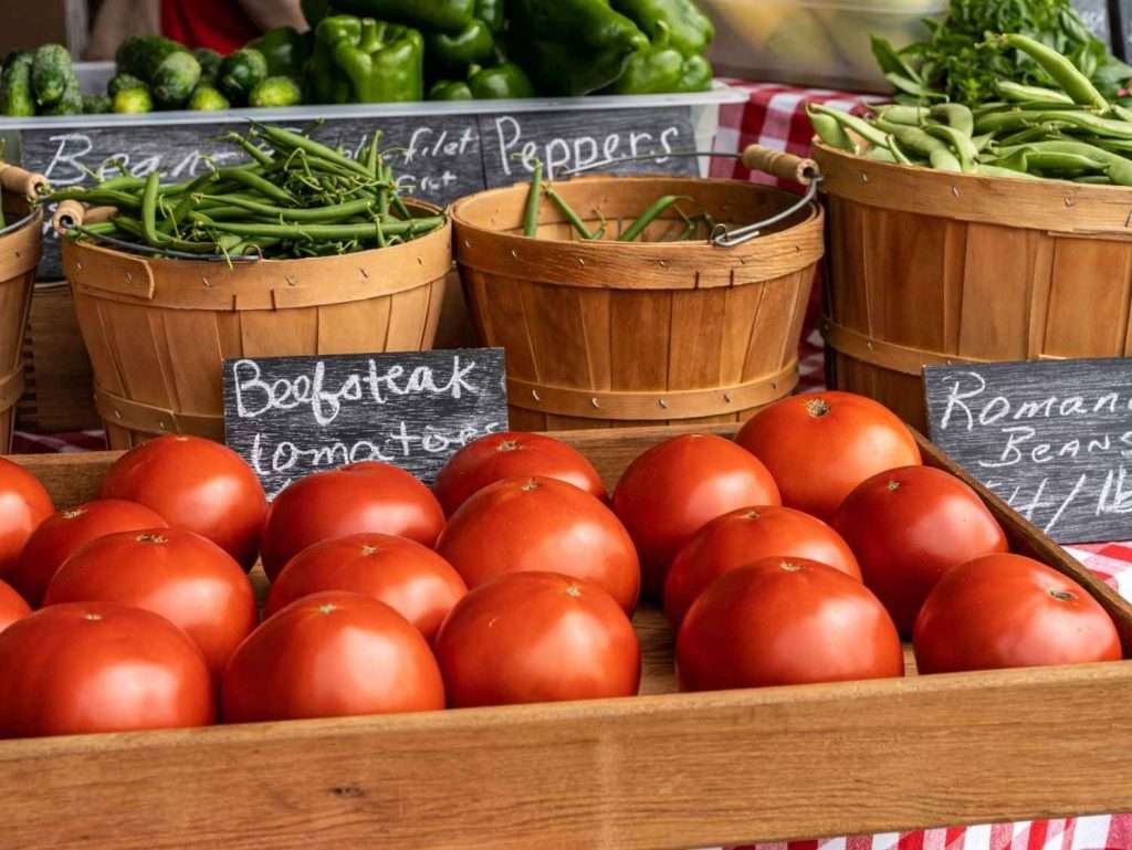 tomatoes at a farmers market stand