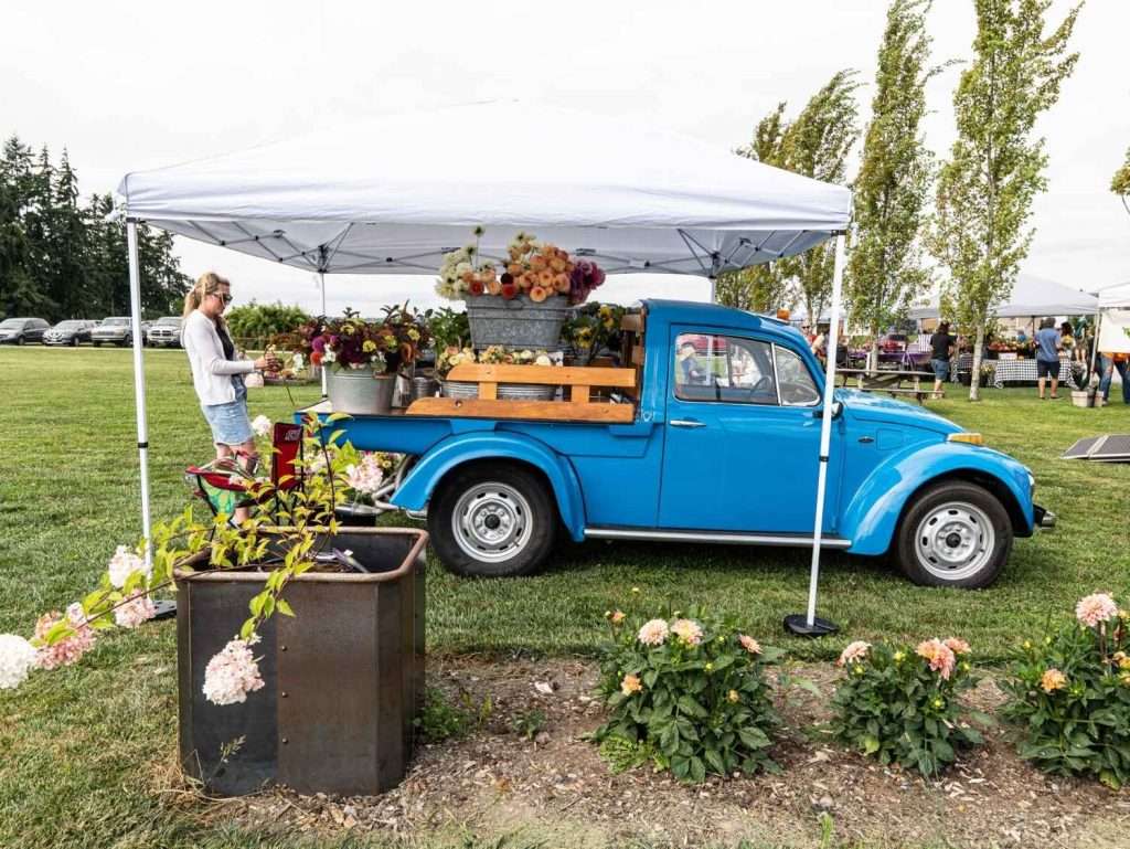 blue truck with flowers in the bed